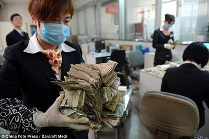 Nh&acirc;n vi&ecirc;n ng&acirc;n h&agrave;ng cho&aacute;ng với 15 bao tiền lẻ của kh&aacute;ch 4